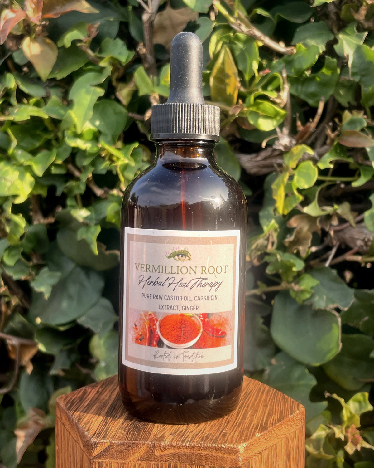 Close-up of an amber dropper bottle labeled Vermilion Root Herbal Heat Therapy